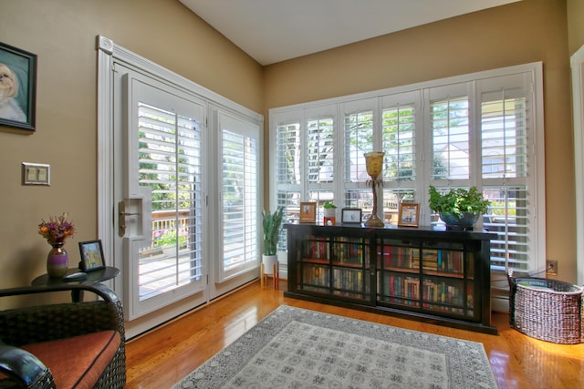 doorway to outside with a wealth of natural light and wood finished floors