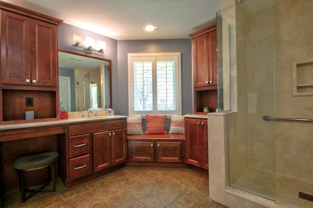 full bathroom featuring vanity, tile patterned floors, and a stall shower