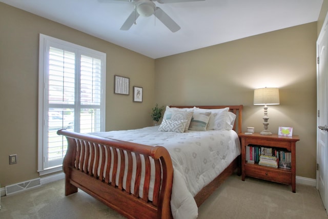 bedroom featuring visible vents, carpet, baseboards, and multiple windows