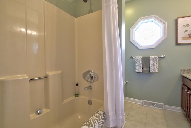 bathroom featuring tile patterned flooring, vanity, shower / bath combo with shower curtain, baseboards, and visible vents