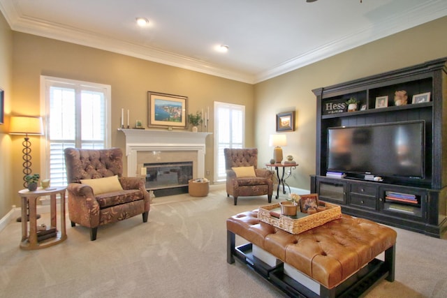 living area with plenty of natural light, carpet flooring, a glass covered fireplace, and ornamental molding