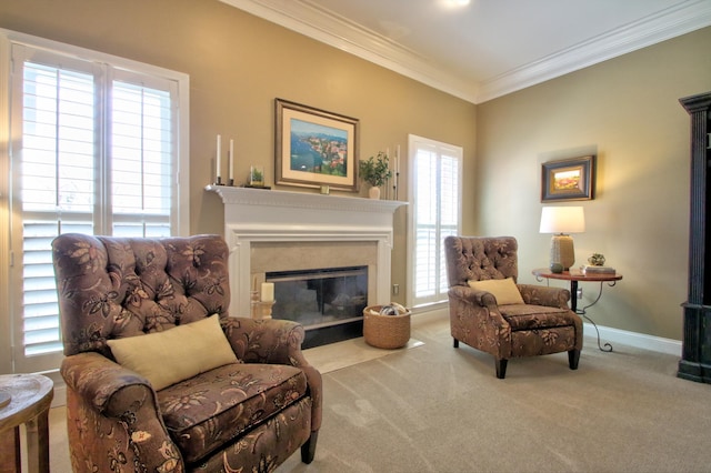 sitting room with crown molding, a high end fireplace, carpet flooring, and a wealth of natural light