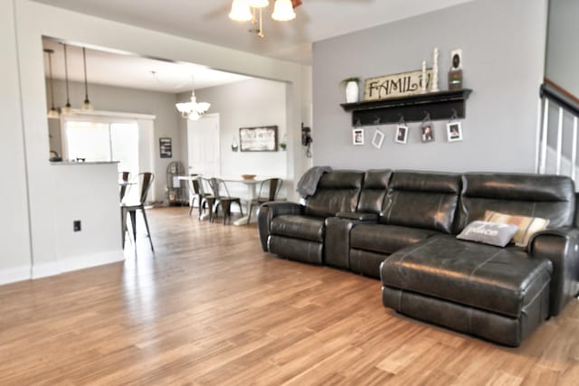 1105 Locust Fork Rd, Stamping Ground, KY 40379 - living area featuring wood finished floors and ceiling fan with notable chandelier