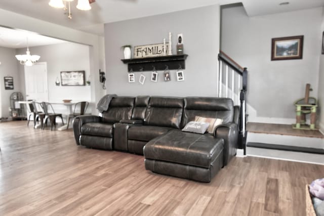1105 Locust Fork Rd, Stamping Ground, KY 40379 - living room with ceiling fan with notable chandelier, baseboards, and wood finished floors