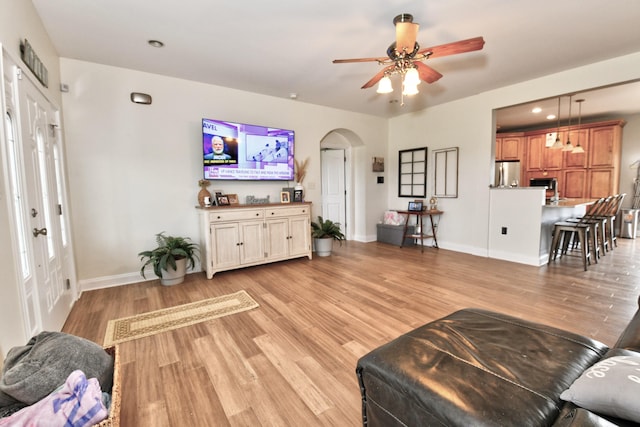 1105 Locust Fork Rd, Stamping Ground, KY 40379 - living area with a ceiling fan, light wood-type flooring, arched walkways, french doors, and baseboards