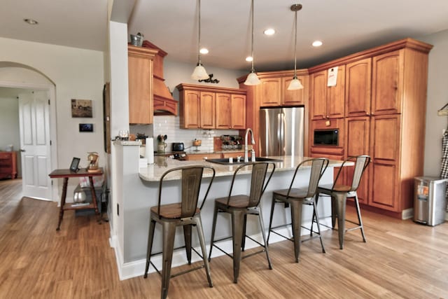 1105 Locust Fork Rd, Stamping Ground, KY 40379 - kitchen featuring built in microwave, a sink, arched walkways, freestanding refrigerator, and a peninsula
