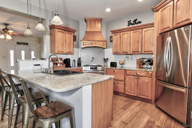 1105 Locust Fork Rd, Stamping Ground, KY 40379 - kitchen featuring light stone counters, stainless steel appliances, a breakfast bar, a sink, and custom range hood