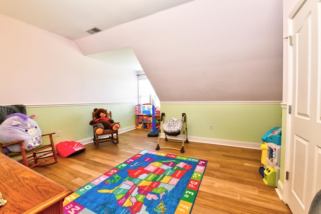 1105 Locust Fork Rd, Stamping Ground, KY 40379 - playroom featuring vaulted ceiling, wood finished floors, visible vents, and baseboards