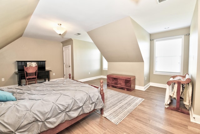 1105 Locust Fork Rd, Stamping Ground, KY 40379 - bedroom featuring baseboards, visible vents, multiple windows, lofted ceiling, and wood finished floors