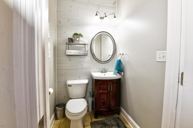 1105 Locust Fork Rd, Stamping Ground, KY 40379 - half bath featuring wood walls, vanity, baseboards, toilet, and tile patterned flooring