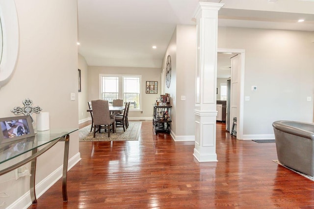 interior space with decorative columns, baseboards, dark wood-style floors, and recessed lighting