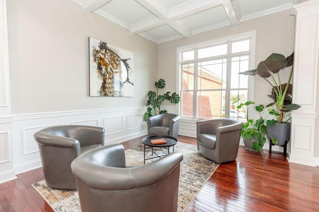 sitting room with ornamental molding, wainscoting, coffered ceiling, wood-type flooring, and beam ceiling