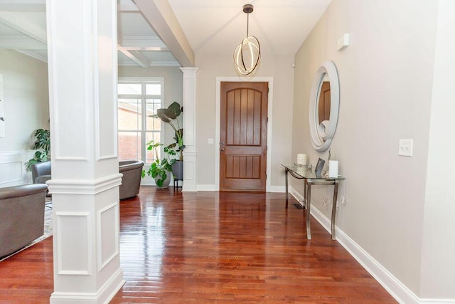 entryway featuring ornate columns, beam ceiling, and wood finished floors
