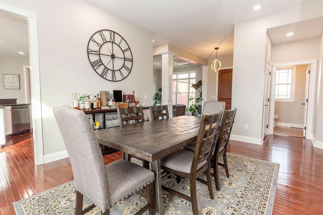 dining space featuring recessed lighting, hardwood / wood-style flooring, ornate columns, and baseboards