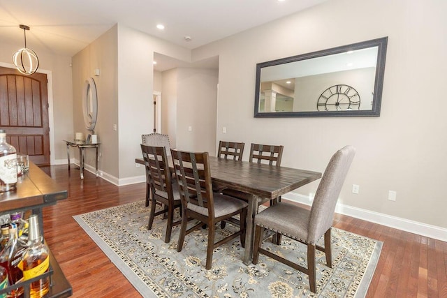 dining room featuring recessed lighting, baseboards, and wood finished floors