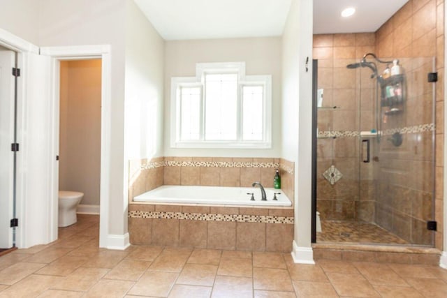 full bath with toilet, tile patterned floors, a bath, and a shower stall