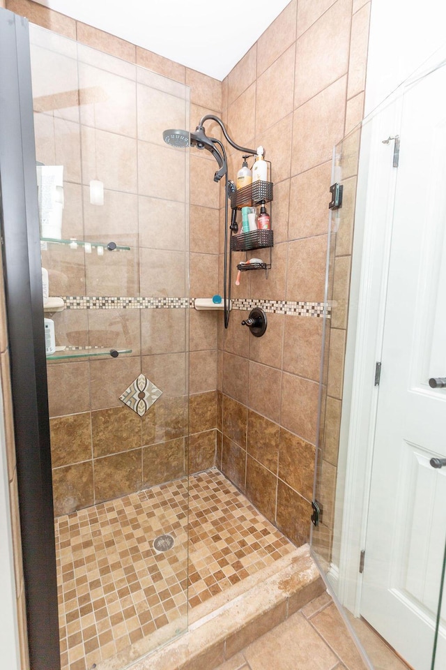 bathroom featuring tile patterned flooring and a stall shower