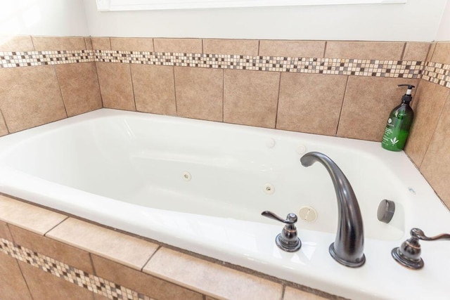bathroom with a tub with jets