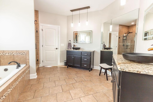 bathroom featuring a shower stall, tile patterned floors, vanity, and a garden tub