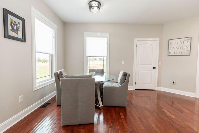 dining space featuring visible vents, baseboards, and hardwood / wood-style floors