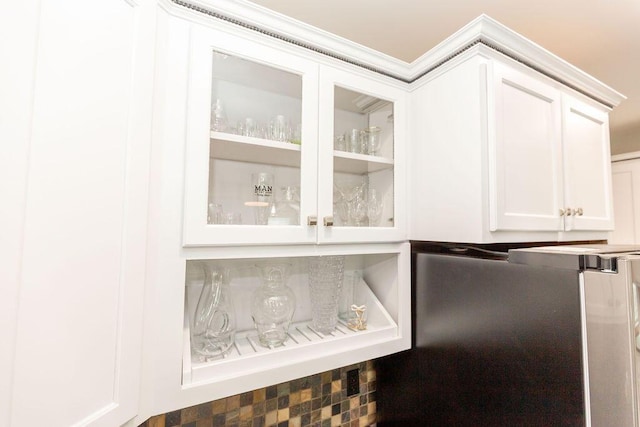 room details with white cabinets, glass insert cabinets, and a dry bar
