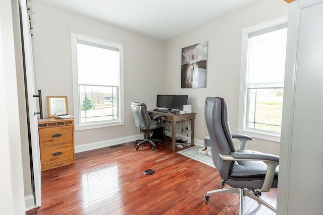 office featuring visible vents, baseboards, and hardwood / wood-style floors