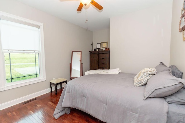 bedroom with baseboards, wood-type flooring, a ceiling fan, and visible vents