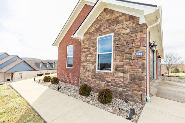 view of side of home featuring stone siding