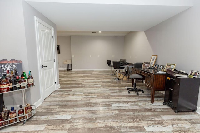 home office with light wood-style flooring, baseboards, and recessed lighting