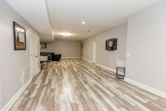 interior space with light wood-type flooring, baseboards, visible vents, and recessed lighting
