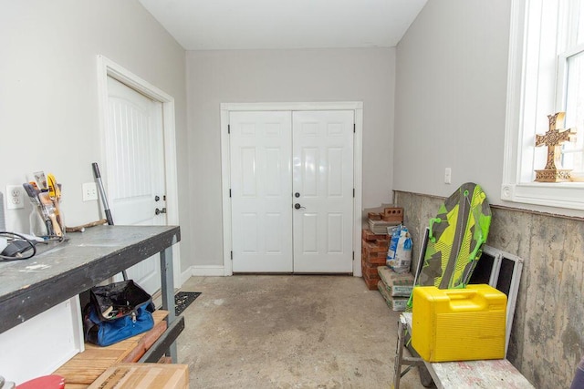foyer featuring unfinished concrete flooring