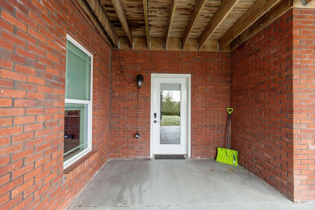 view of exterior entry with brick siding