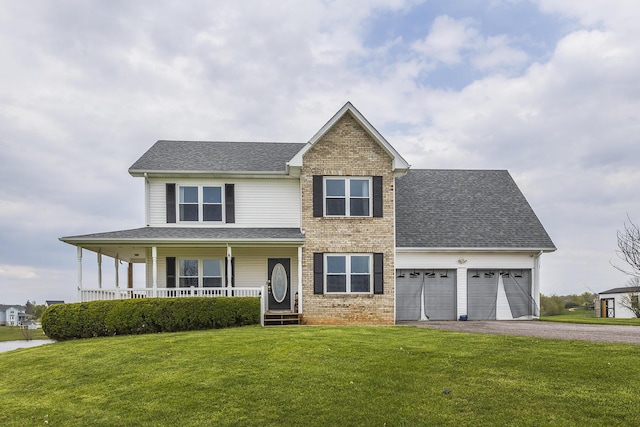 view of front of property featuring a front lawn, an attached garage, driveway, a porch, and brick siding