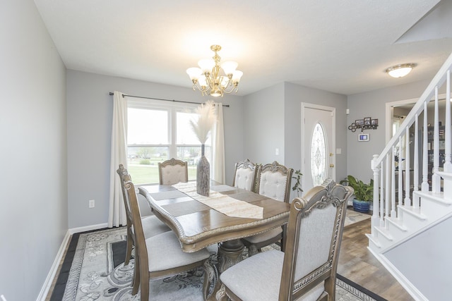 dining room with stairway, baseboards, and a chandelier