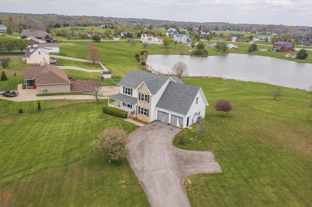 birds eye view of property with a water view