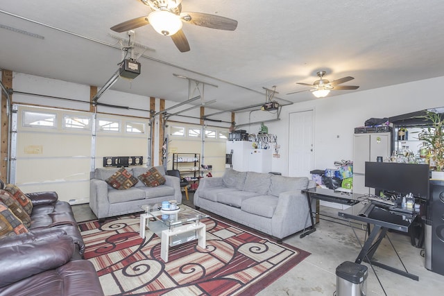 living area with ceiling fan, concrete floors, and a garage