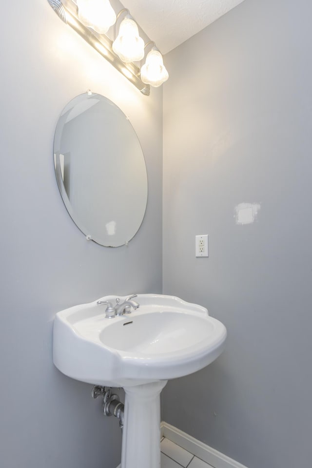 bathroom with tile patterned flooring and baseboards