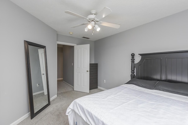 bedroom with ceiling fan, light carpet, visible vents, and baseboards
