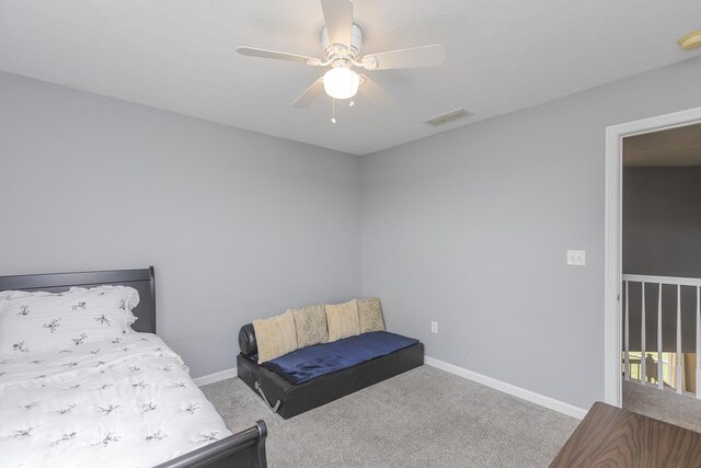 carpeted bedroom with ceiling fan, baseboards, and visible vents