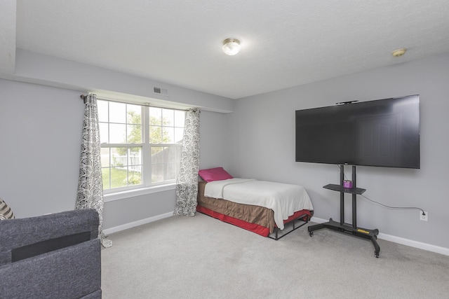 bedroom featuring baseboards, carpet floors, and visible vents