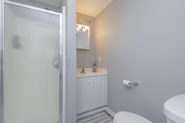 full bath featuring a stall shower, toilet, visible vents, tile patterned flooring, and vanity
