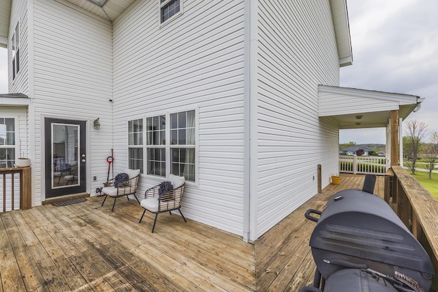 wooden deck featuring area for grilling