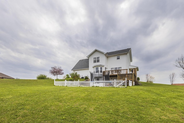 back of property with a lawn, stairs, fence, and a deck