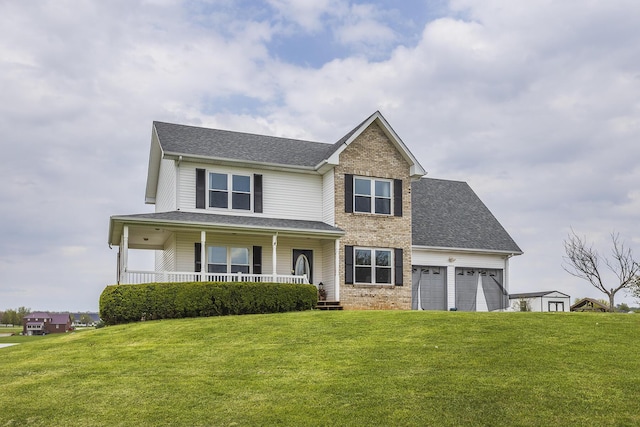 view of front of home with a porch, an attached garage, roof with shingles, and a front yard