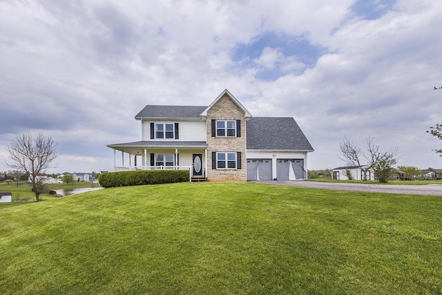 view of front of home with aphalt driveway, covered porch, a front yard, a garage, and brick siding