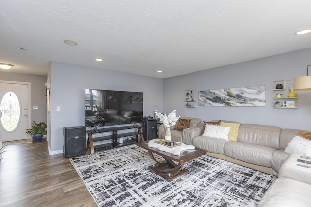 living area featuring baseboards, wood finished floors, and recessed lighting