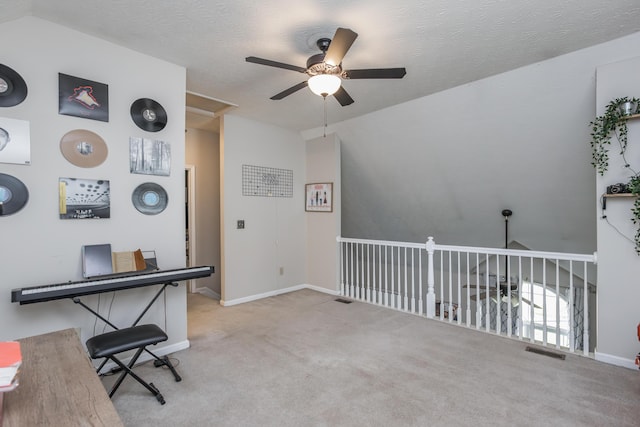 carpeted home office featuring ceiling fan, baseboards, vaulted ceiling, and visible vents