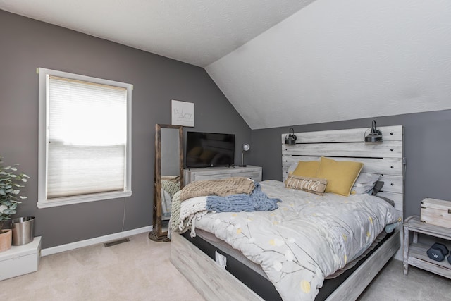 carpeted bedroom featuring lofted ceiling, visible vents, and baseboards