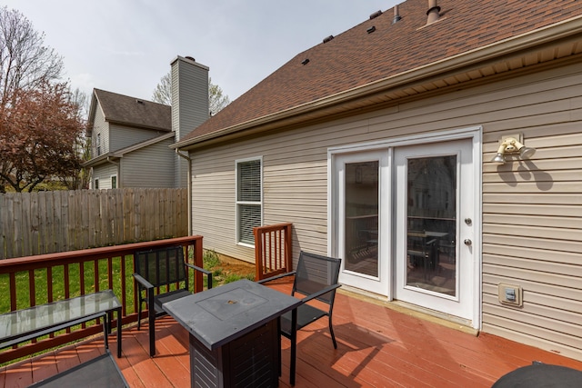 deck with outdoor dining area and fence
