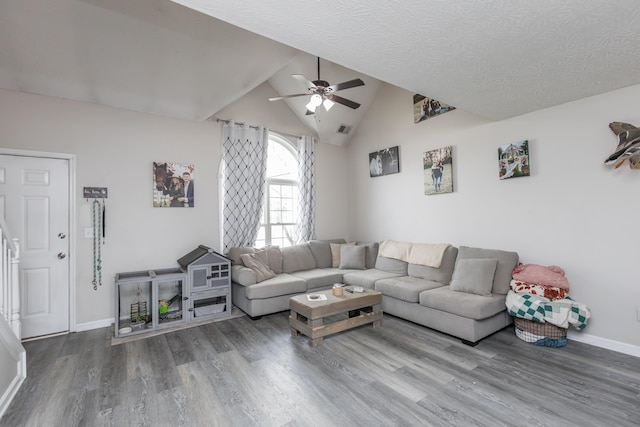 living area featuring a ceiling fan, wood finished floors, baseboards, lofted ceiling, and visible vents